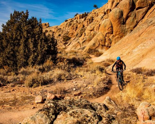 A person mountain biking on a trail at Hartman Rocks in Gunnison. Hartman Rocks is a mountain biking mecca in the Gunnison Valley